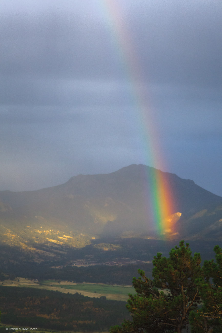 Late afternoon thunderstorm produces a rainbow over the valley. View seen from Many Parks Curve.