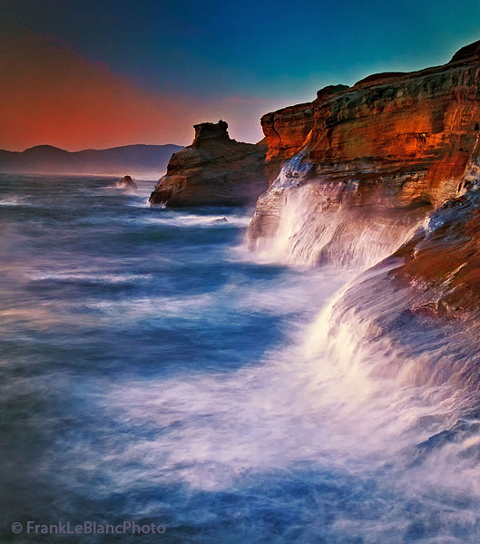 The setting sun joined by roaring waves as they explode against the shore cliffs. Turbulence with loud booms