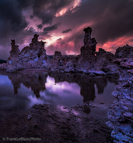 Backlighted storm clouds move across Mono Lake creating a staged effect which mimics   Wagnerian opera. Shadows of idolic tufa...