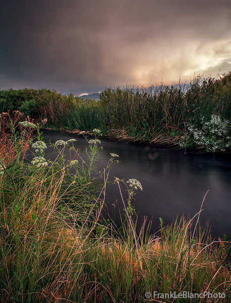 With the sun setting over the volcanic  tableland wind began to gust forcefully and ominous storm clouds formed up over the sierra...