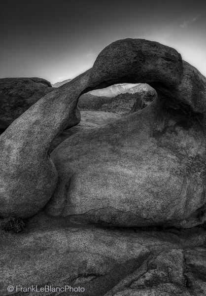 Mobius arch at sunset. An intense ray of light squeezes under this massive granite arch/boulder.