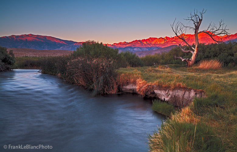Sunrise over the Owens River and volcanic tableland. The Sierra Nevada mountains dominate the background, while also seen, albeit...