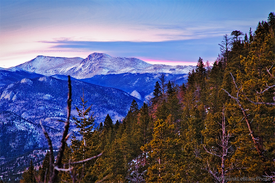 January snow on Longs Peak, Mt. Meeker and Mt. Lady Washington. Twilight glow casts its spell over mountains and forest.